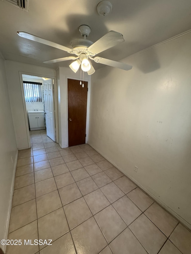 unfurnished room featuring light tile patterned floors and a ceiling fan