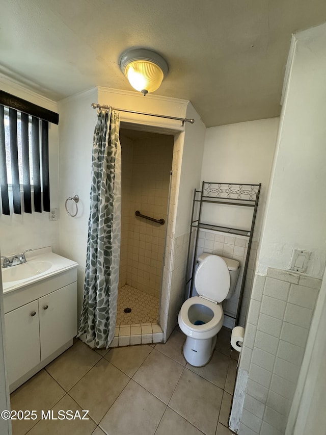 full bath with toilet, a stall shower, tile patterned flooring, and vanity