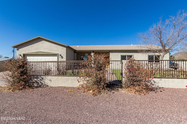 ranch-style home with a garage, a fenced front yard, and stucco siding