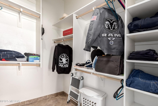 spacious closet with tile patterned floors