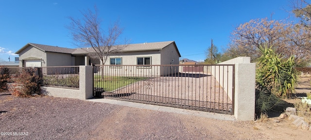 view of front of property with a fenced front yard and stucco siding