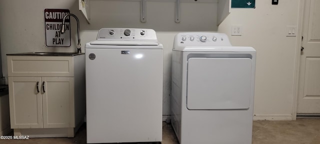 laundry room with cabinet space and washing machine and clothes dryer