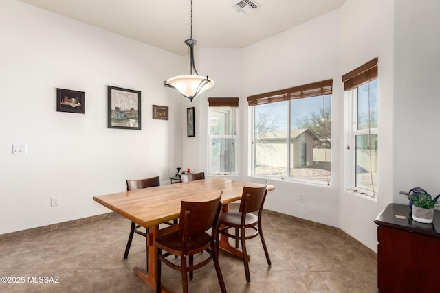 dining space featuring baseboards, visible vents, and light tile patterned flooring