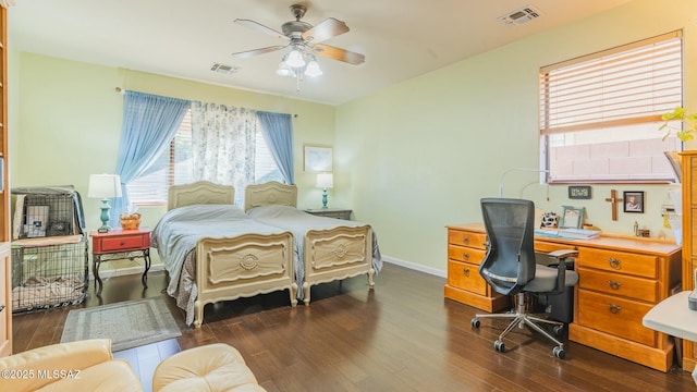 bedroom with dark wood-style floors, baseboards, and visible vents