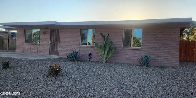 single story home with a patio area and fence