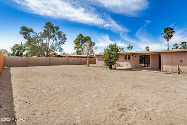 view of yard with a fenced backyard and a patio area