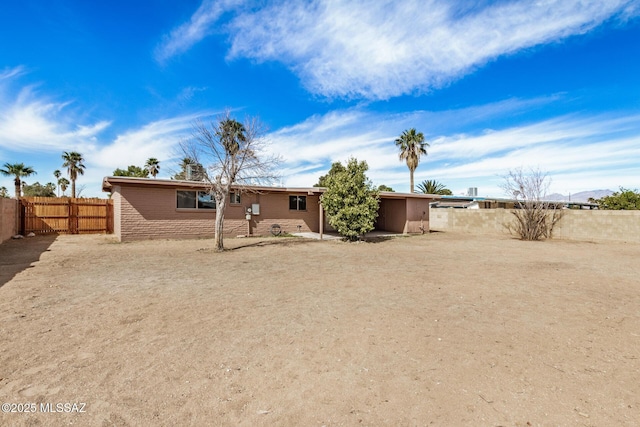 back of house with a fenced backyard