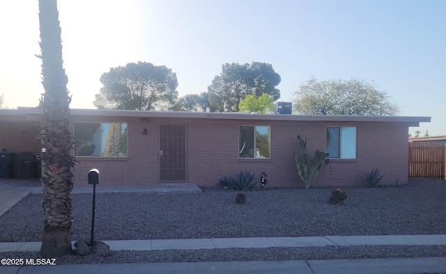 ranch-style house featuring brick siding