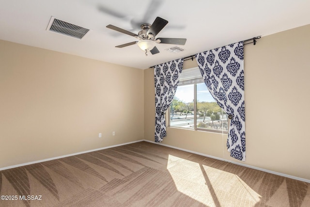 spare room featuring baseboards, visible vents, ceiling fan, and carpet flooring