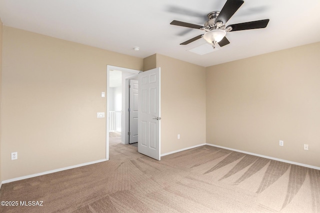 unfurnished bedroom with carpet floors, a ceiling fan, and baseboards