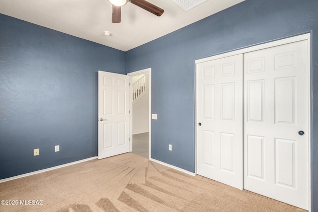 unfurnished bedroom featuring a closet, visible vents, baseboards, and carpet flooring