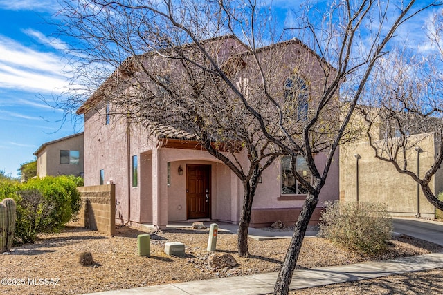 view of front of home with a tile roof and stucco siding