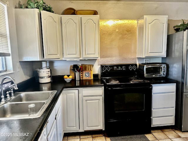 kitchen featuring black / electric stove, dark countertops, a sink, and a toaster