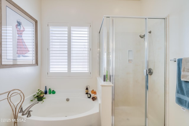 bathroom featuring a stall shower and a bath