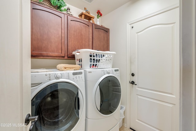 laundry area with washing machine and dryer and cabinet space
