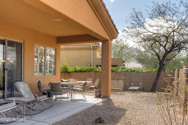 view of patio / terrace featuring fence and outdoor dining space