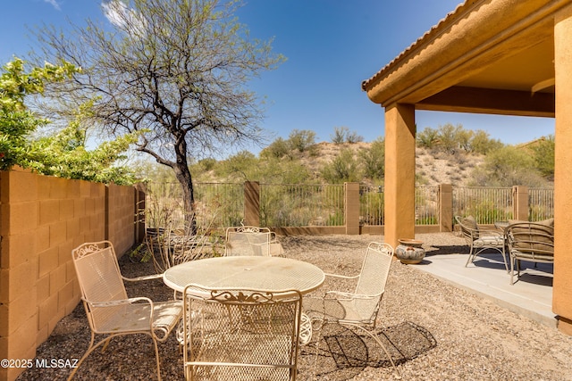 view of patio with a fenced backyard and outdoor dining space