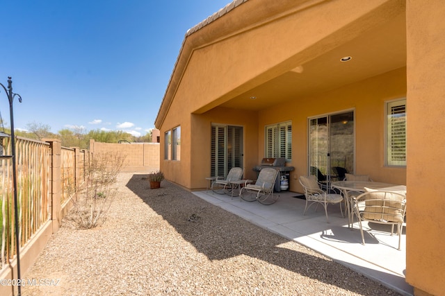 exterior space featuring a fenced backyard, stucco siding, and a patio area