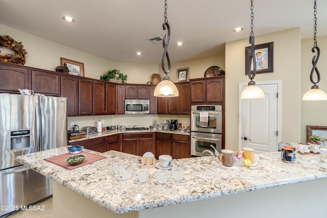 kitchen featuring light stone countertops, stainless steel appliances, a spacious island, and dark brown cabinets