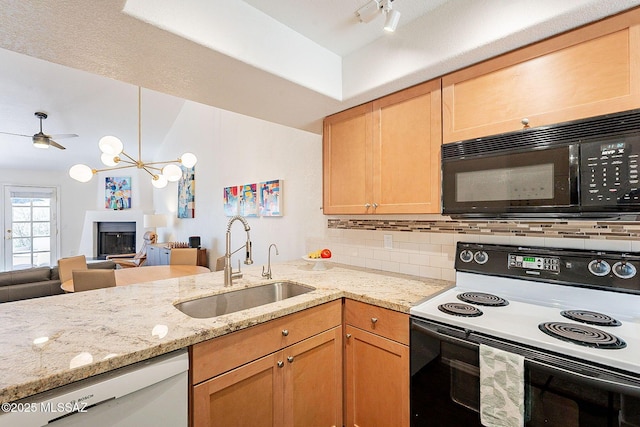 kitchen with tasteful backsplash, a fireplace with raised hearth, a sink, range with electric cooktop, and black microwave