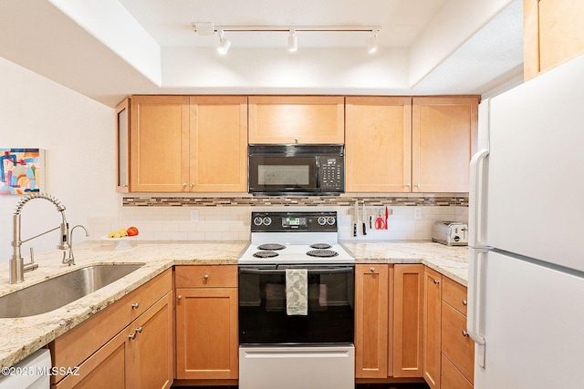 kitchen with white appliances, backsplash, a sink, and light stone countertops