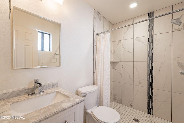 full bathroom with toilet, a shower stall, and vanity