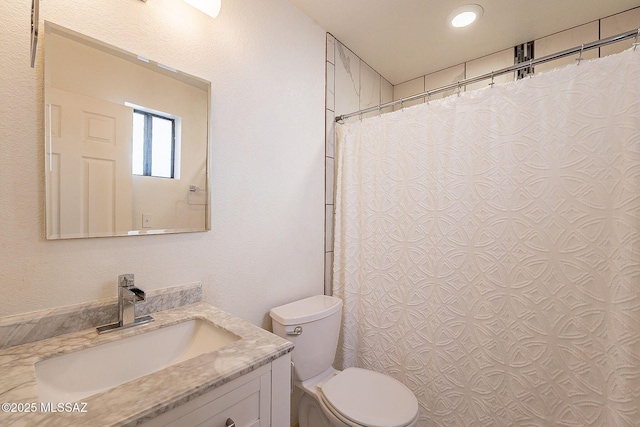 full bath featuring curtained shower, vanity, and toilet