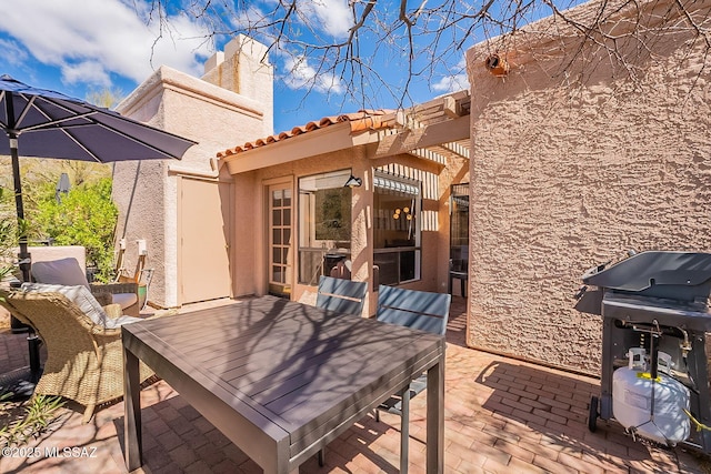 view of patio featuring area for grilling and a pergola