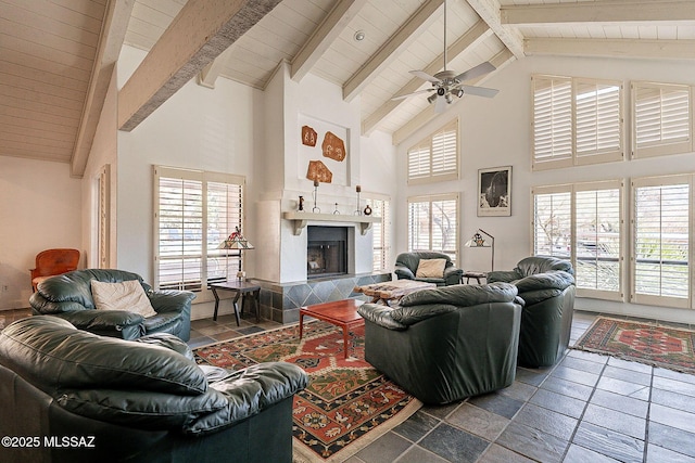 living room featuring high vaulted ceiling, a fireplace, and beamed ceiling