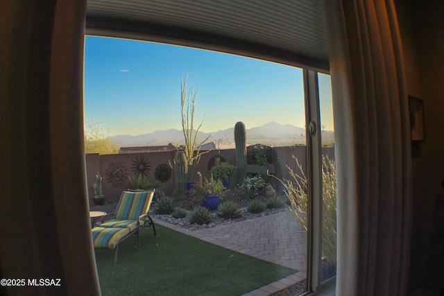 interior space with a fenced backyard and a mountain view