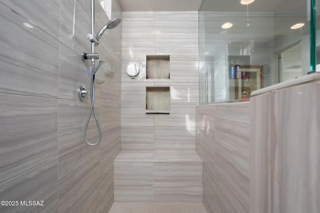 bathroom with tiled shower