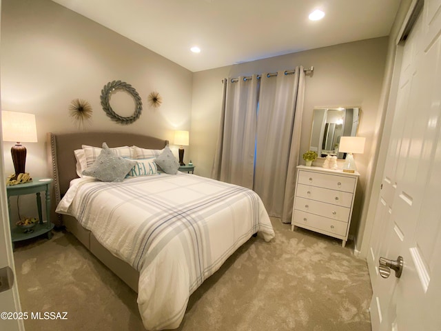 bedroom with light carpet, a closet, and recessed lighting