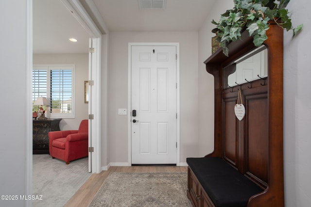 mudroom featuring light wood finished floors, baseboards, and visible vents