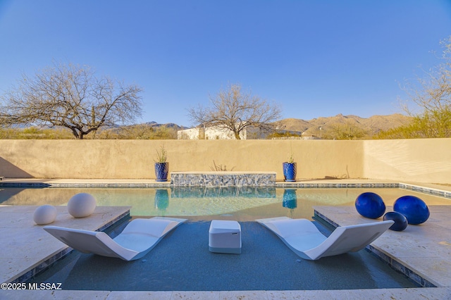 view of pool with a patio area, a mountain view, and a fenced in pool