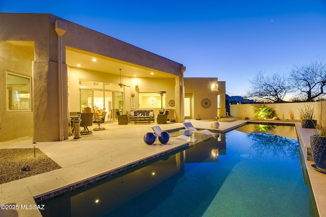 view of swimming pool with a patio, a ceiling fan, an outdoor living space, and a fenced in pool