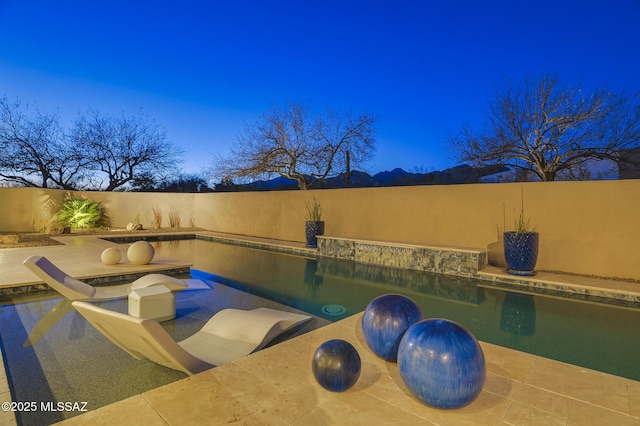 view of swimming pool featuring a patio area, fence, and a fenced in pool