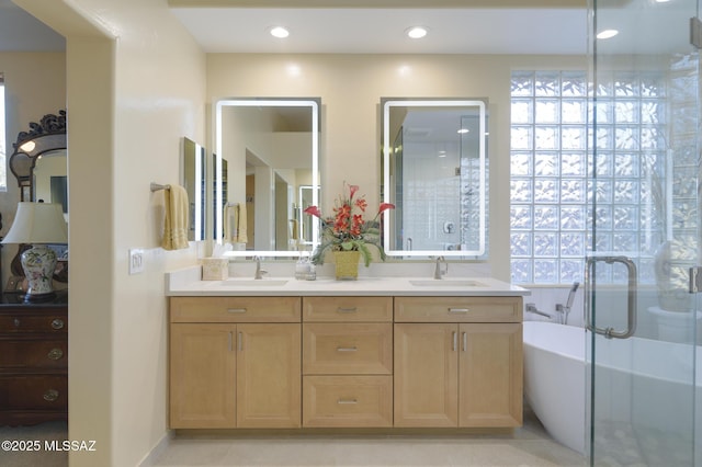 full bathroom with a stall shower, a sink, a freestanding bath, and double vanity