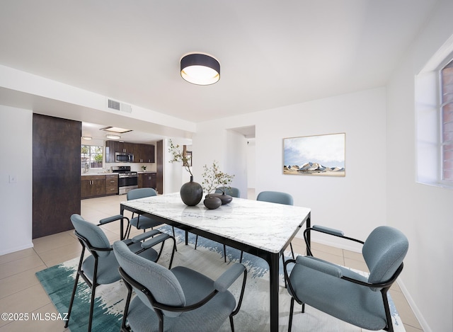 dining area with visible vents, baseboards, and light tile patterned floors