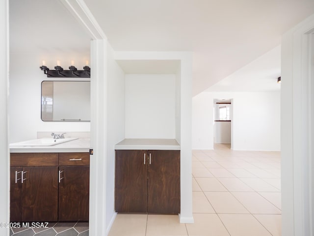 interior space featuring light tile patterned floors and a sink