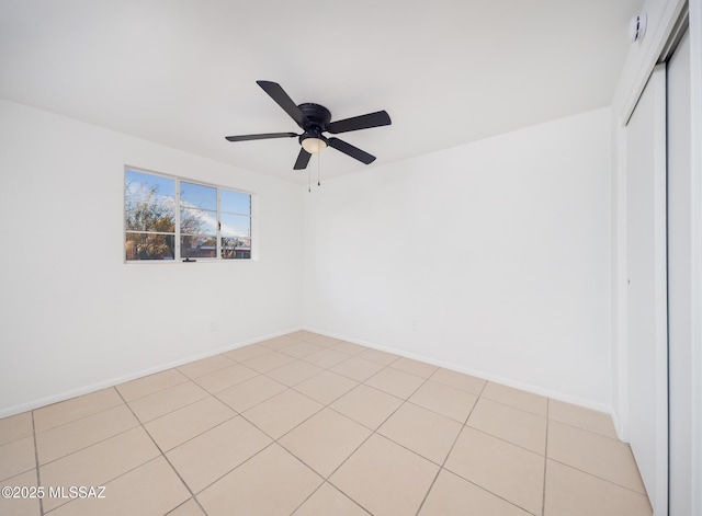 unfurnished room featuring ceiling fan and baseboards