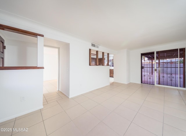 spare room with light tile patterned floors, visible vents, and baseboards