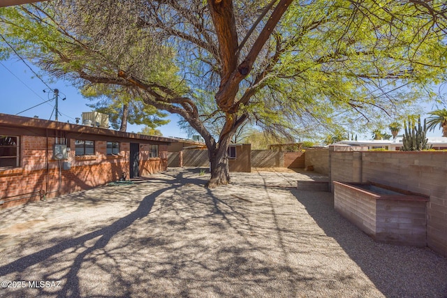 view of yard featuring a patio area and a fenced backyard