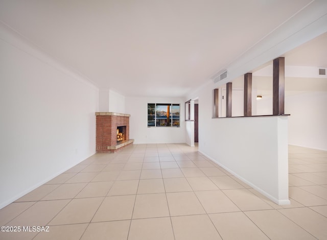 unfurnished living room featuring light tile patterned floors, a fireplace, and visible vents