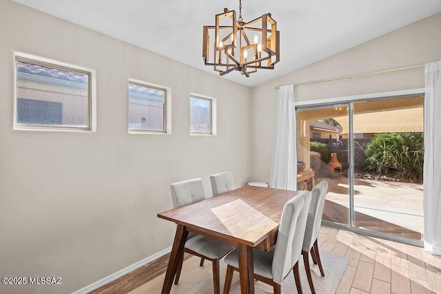 living room featuring light wood-style flooring, baseboards, visible vents, lofted ceiling, and ceiling fan with notable chandelier