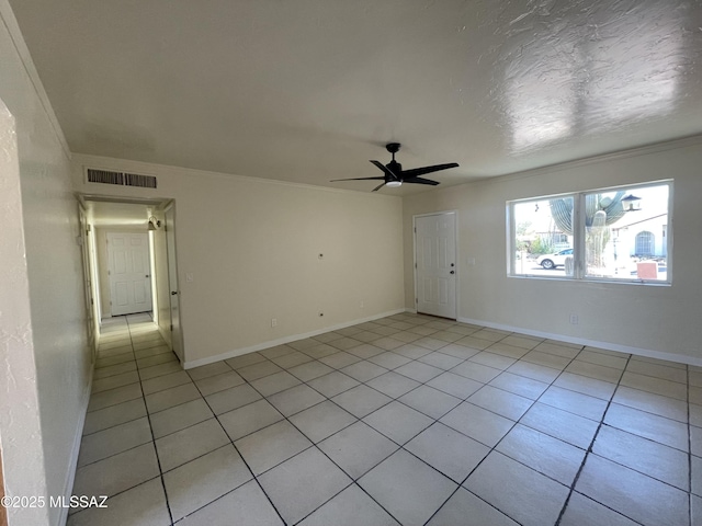 unfurnished room with a ceiling fan, visible vents, baseboards, and light tile patterned floors