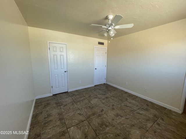 unfurnished bedroom featuring ceiling fan, visible vents, and baseboards