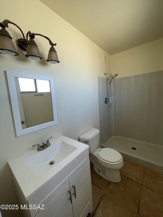 full bath featuring tile patterned flooring, vanity, toilet, and a shower stall