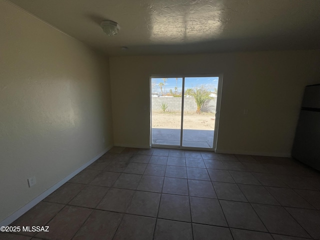 tiled spare room with baseboards