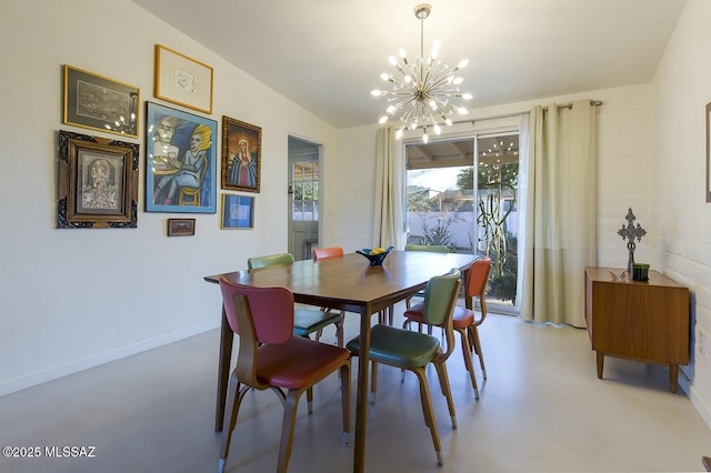 dining area with concrete floors, baseboards, and an inviting chandelier