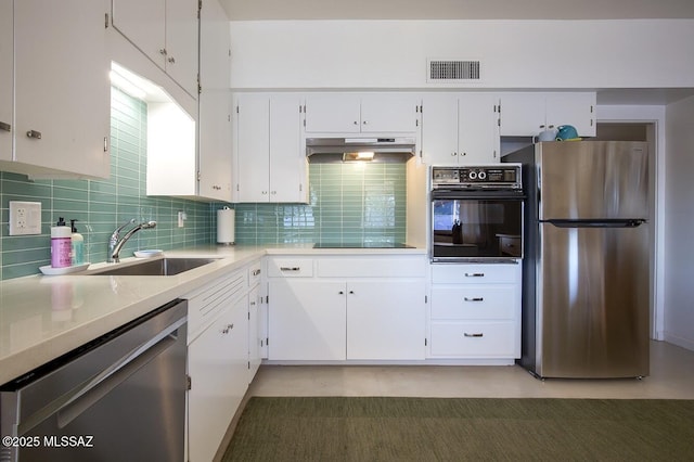 kitchen with visible vents, light countertops, white cabinetry, under cabinet range hood, and black appliances